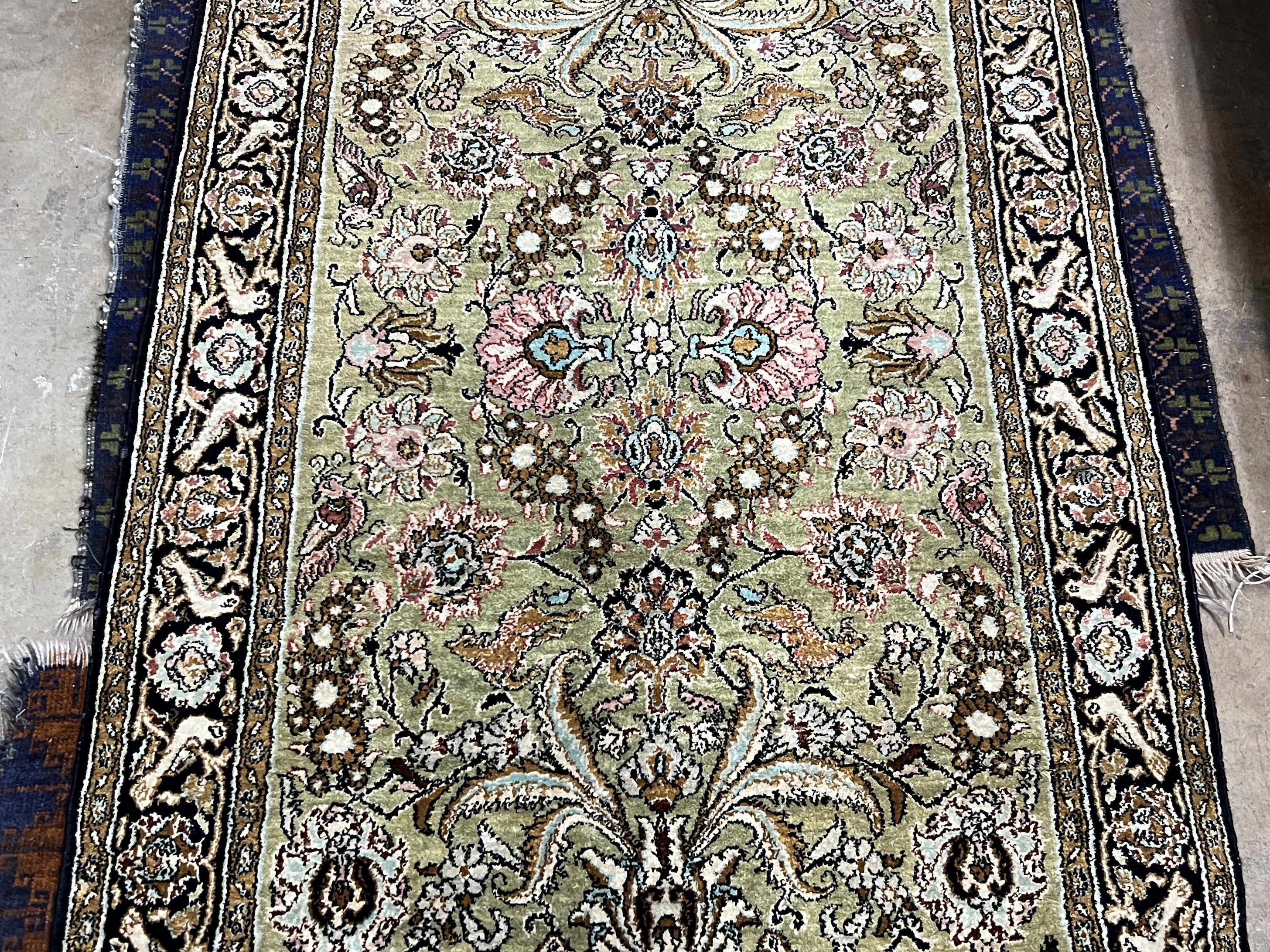 A Kashan part silk rug, woven with animals among flower heads, 130 x 77cm